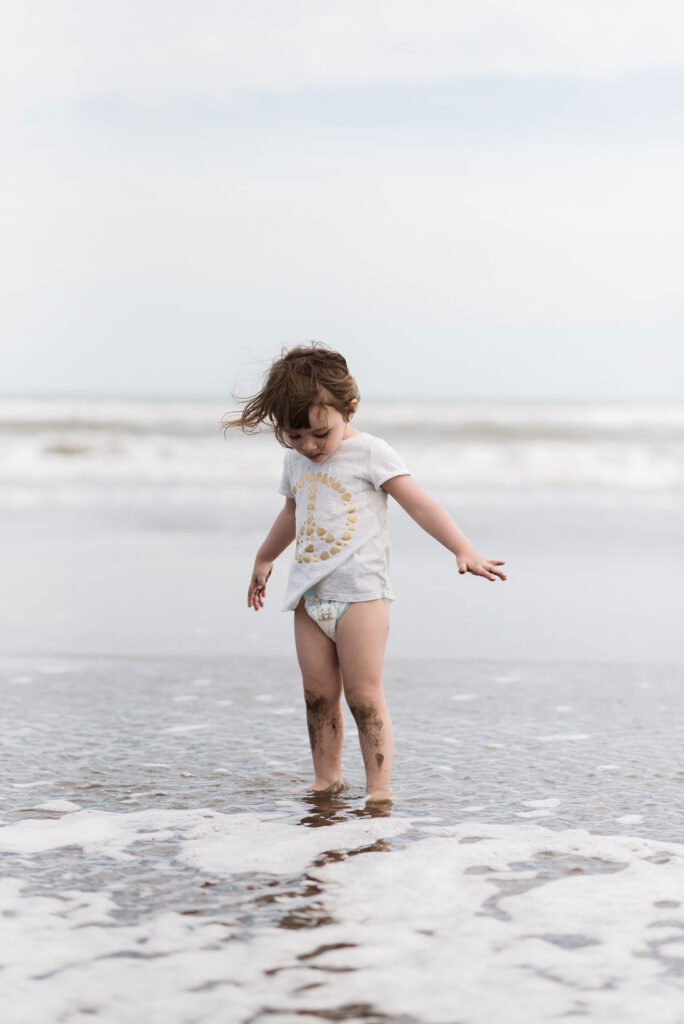 Toddler playing at the water’s edge – beach family photos Bloemendaal aan Zee