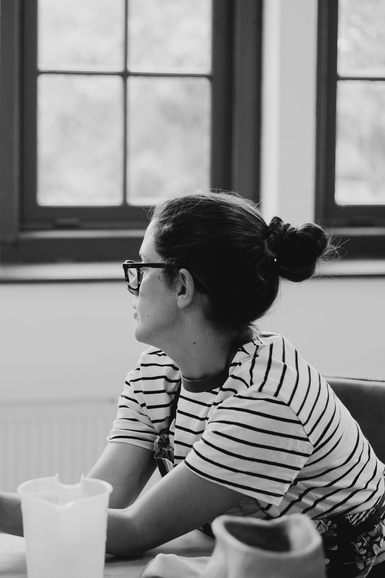 Ceramic artist in her studio looking out the window, black and white personal branding photo by Pau Granillo in Haarlem