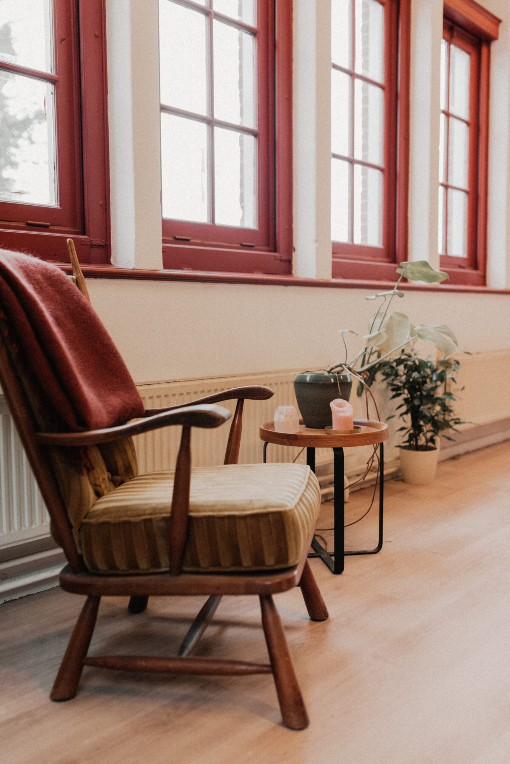 Empty coworking space with a vintage armchair by the window, photographed by Pau Granillo