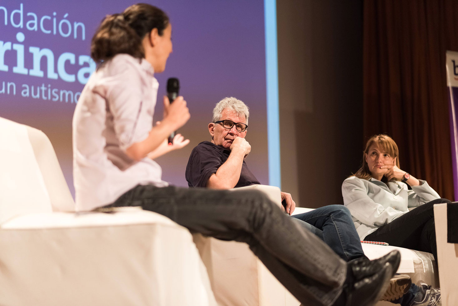 Speakers on stage during a panel talk at a foundation conference