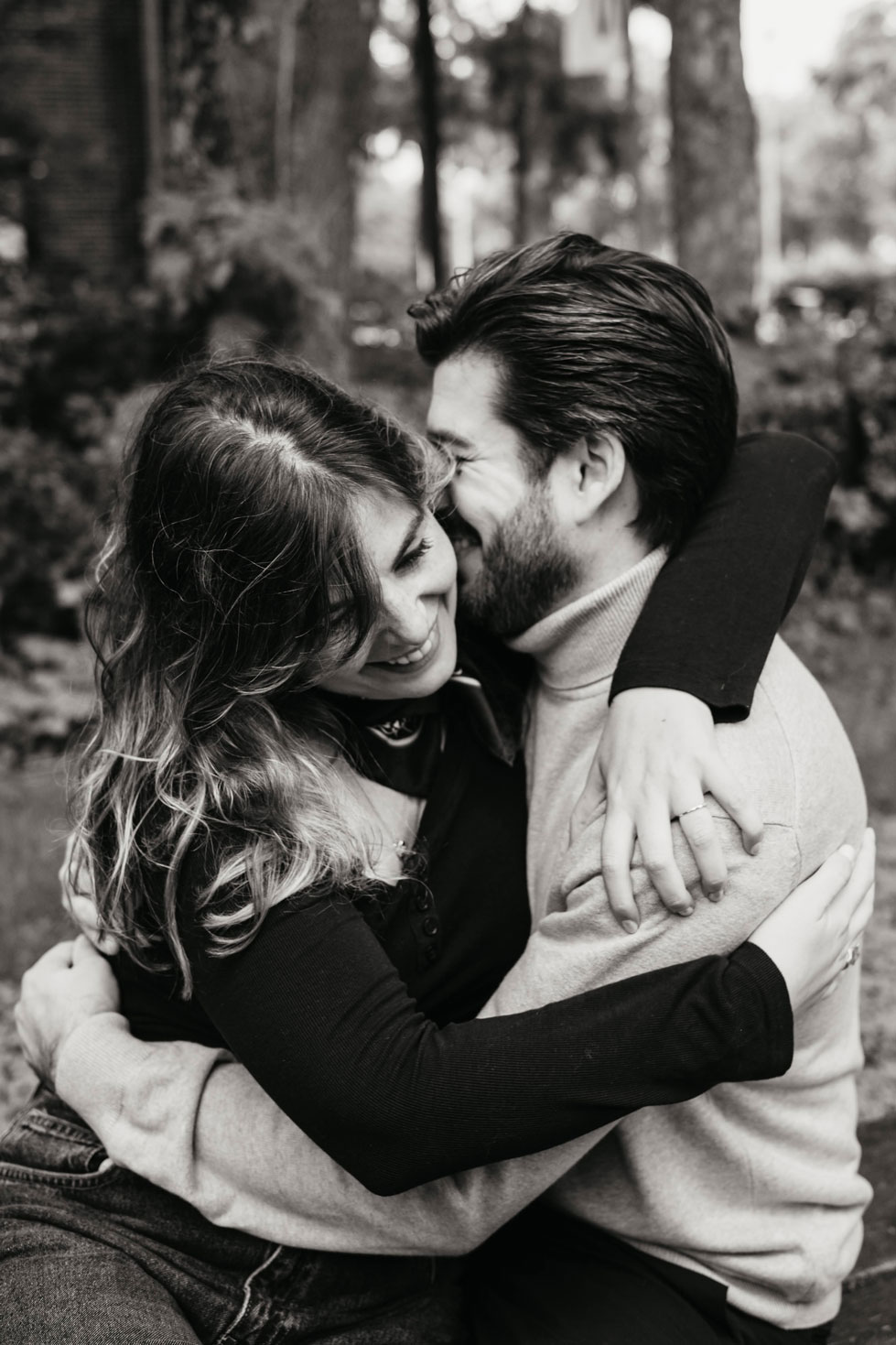 Parents hugging and laughing together during a family photoshoot in Westerpark, Amsterdam